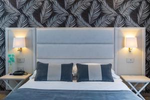 Letto o letti in una camera di Hotel Rombino