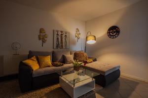 a living room with a couch and a table at Apartmani "A View to the Danube" in Vukovar