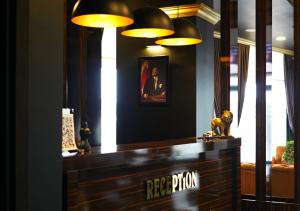 a hotel lobby with a reception desk and lights at OTTOMAN İSTANBUL AİRPORT OTEL in Istanbul