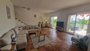 a living room with a couch and a table at VILLA AUGUSTINA in Sainte-Maxime