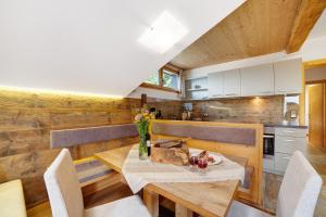 a kitchen and dining room with a table and chairs at Oberhof Apt Nagelstein in Larcher
