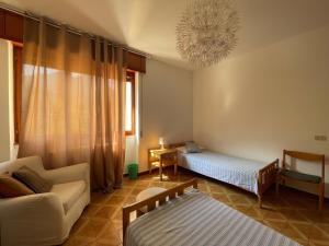 a living room with two beds and a couch at [come a Casa] da Marina in Pieve Vergonte