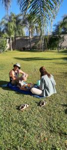 two people sitting on the grass in a park at Umbrella 1 in La Rioja +15 photos