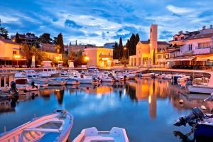 a group of boats are docked in a harbor at Apartments Bella Vita 1 in Malinska +34 photos