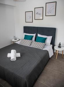a bedroom with a large bed with two tables at Ammira Mare Apartment in Agia Pelagia