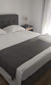 A bed or beds in a room at Menta House