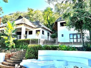 a white house with stairs in front of it at ScenicViews@103 in Hartbeespoort