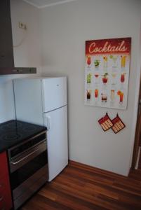 a kitchen with a refrigerator and a cocacola sign on the wall at Ferienwohnung Kirchbergblick in Hackenheim