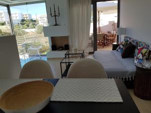 a living room with a bed and a table and chairs at RVG Rania House with pool in Porto Heli