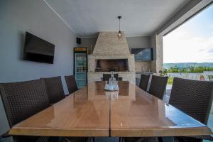 a dining room with a wooden table and chairs at Villa Vukas in Mostar