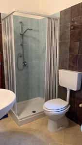 a bathroom with a shower with a toilet and a sink at Home Plutone in Giardini Naxos +6 photos