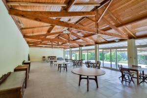 a large room with tables and chairs and windows at Morgado - River Suites and Houses by PCH in Padrões