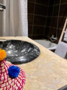 a bathroom counter with a sink and a flower on it at Surf Lovers Morocco in Agadir