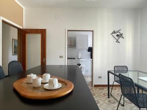a living room with a table and a dining room at [come a Casa] da Marina in Pieve Vergonte