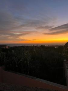 a view of a sunset from a roof of a house at Mare & Montagna in Capitana