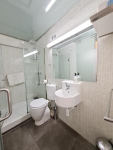 a bathroom with a toilet and a sink and a shower at AsAtHome Arenal Apartment in Madrid