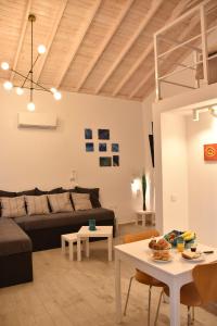 a living room with a couch and a table at The art studio in Samothraki +36 photos