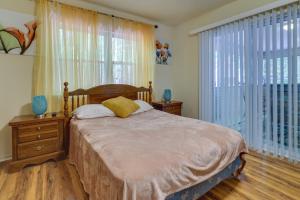 a bedroom with a bed and a large window at Fire Pit, Kayak and Gas Grill Pocono Lake Home! in Pocono Lake