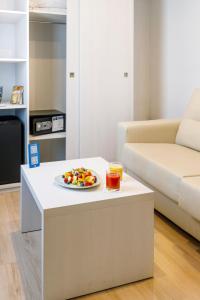 a plate of fruit on a table in a living room at Mar Hotels Alcanada in Port d'Alcudia