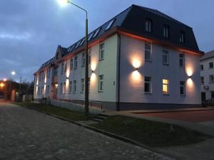 a building with lights on the side of a street at Cozy Apartment Kaija in Liepāja