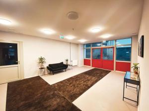 a living room with a black chair and a couch at Cozy Apartment Kaija in Liepāja