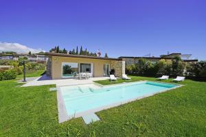 a house with a swimming pool in the yard at Villa Ester by Wonderful Italy in Moniga