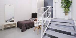 a bedroom with a staircase and a bed in a room at My City Home - Acogedor estudio en Ciudad Lineal in Madrid