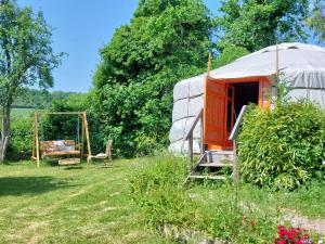 a yurt with a swing and a swing at Yourte Bourgogne in Corvol-dʼEmbernard