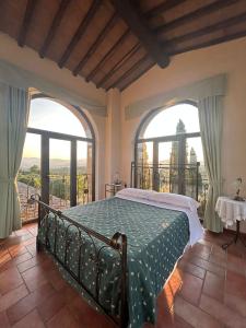 a bedroom with a bed and two large windows at "Villa Bizzi" in Monte Castelli