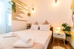 a bedroom with a large white bed with white pillows at BackPacker's Room in Braşov