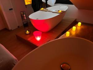 a bath tub sitting on a wooden table with candles at Le Nid d'Amour - Escapade Romantique in Dieppe
