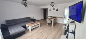 a living room with a couch and a table at Къща за гости Сънрайс Чепеларе in Chepelare