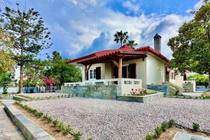 a small white house with a red roof at Hippocrates house in Kos