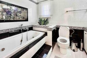 a bathroom with a tub and a toilet and a bath tub at Hippocrates house in Kos Town +66 photos