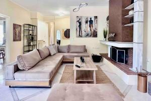 a living room with a couch and a fireplace at Hippocrates house in Kos Town