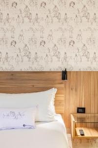 a bedroom with a bed and a wall with a pattern at Rugendas by Time in Santiago