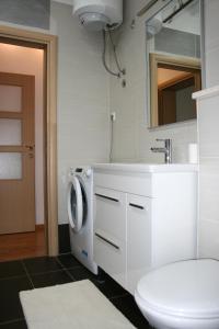 a bathroom with a sink and a washing machine at Apartments Antea in Trogir +32 photos