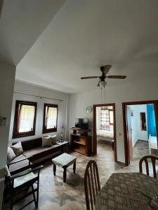 a living room with a couch and a table at Milina's Cozy Riverside Apartments in Milina