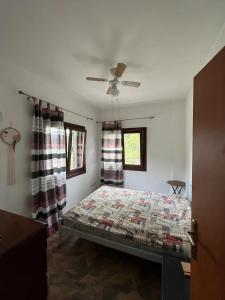 a bedroom with a bed and a ceiling fan at Milina's Cozy Riverside Apartments in Milina