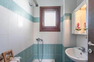 a bathroom with a sink and a toilet and a shower at Milina's Cozy Riverside Apartments in Milina +16 photos