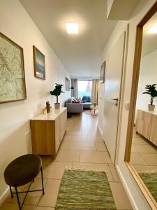 a hallway with a living room with a chair and a table at Bukove Love in Wisła