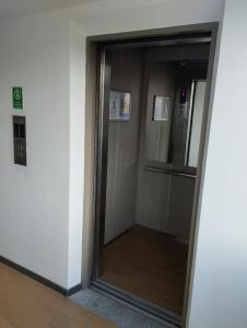 a glass door of an elevator in a building at Cómoda habitación en apartamento in Medellín