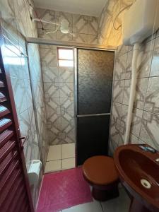 a bathroom with a shower and a toilet and a sink at Pousada Vancele in Bonito