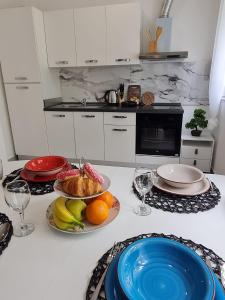 a kitchen with plates of food on a counter at Apartment Alea in Senj