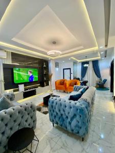 Televiisor ja/või meelelahutuskeskus majutusasutuses Morak homes - Smart luxury 4-bed with private swimming pool, PS5, snooker, mini gym in reserved secured estate
