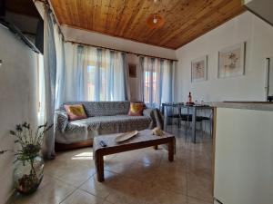 a living room with a couch and a table at Afroditi's 1 in Eresos