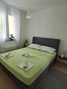 a bedroom with a bed with two towels on it at Apartment Alea in Senj