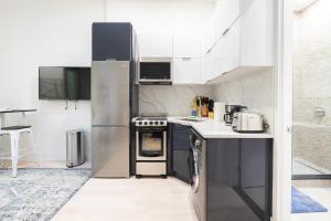 a kitchen with a refrigerator and a stove at 317-4A NEW Modern 1BR W&D Walk to Central Park in New York