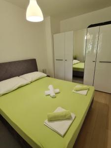 a bedroom with a large bed with towels on it at Apartment Alea in Senj