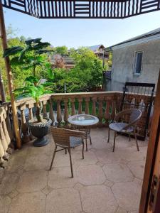 Un patio con sillas y una mesa en el balcón. en Surami Guesthouse, en Surami